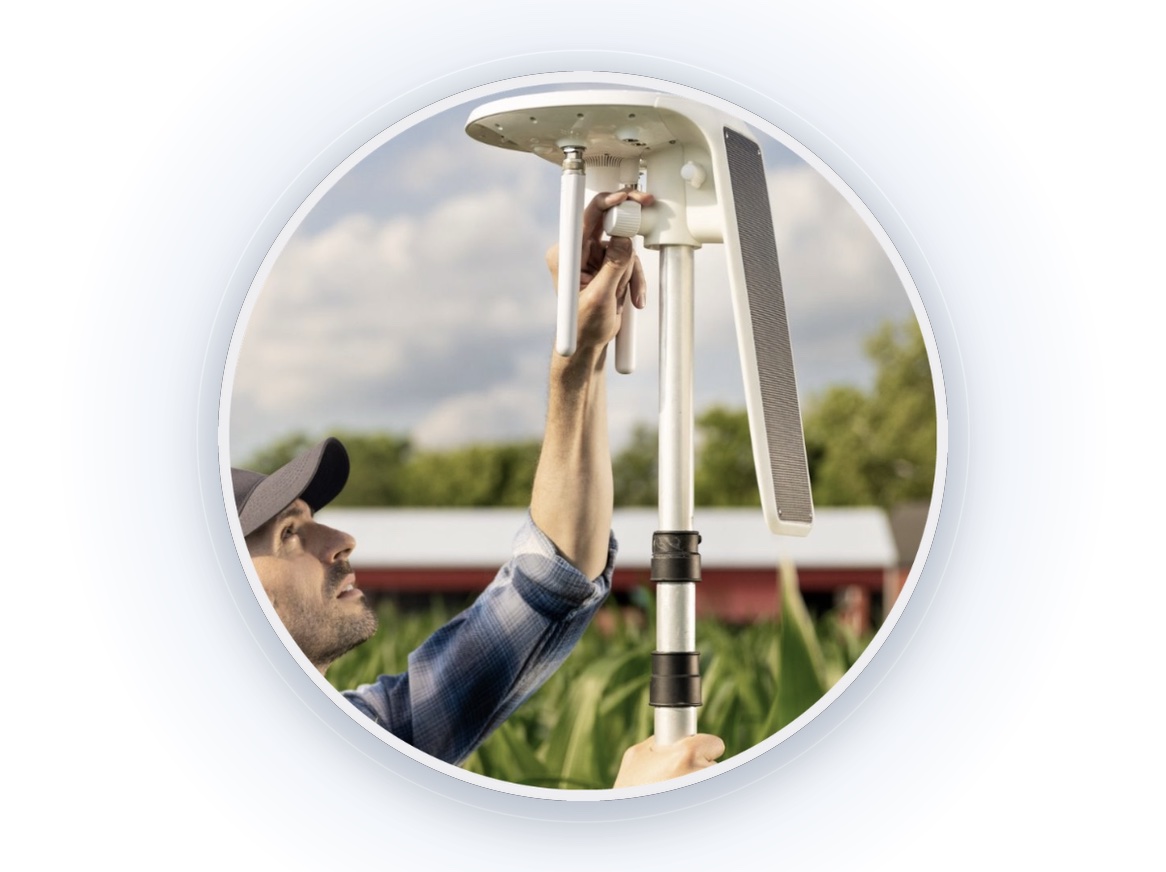Grower installing an Arable Mark 3 sensor in a corn field